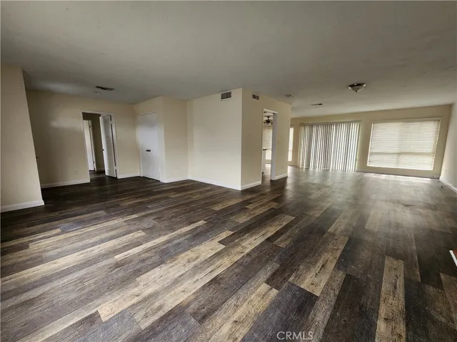 a view of a room with wooden floor