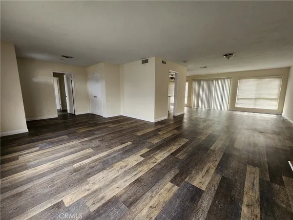 a view of a room with wooden floor