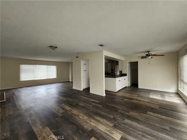 a view of a kitchen with wooden floor and window