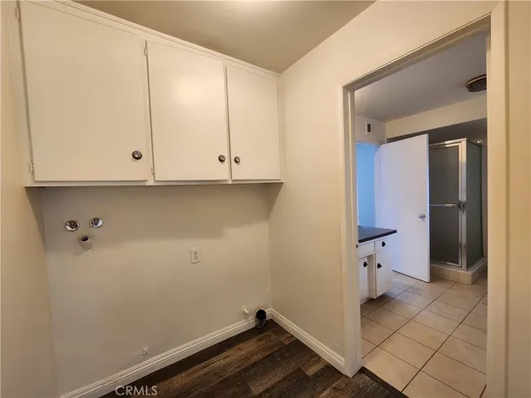 a spacious bathroom with a granite countertop sink a toilet and a mirror