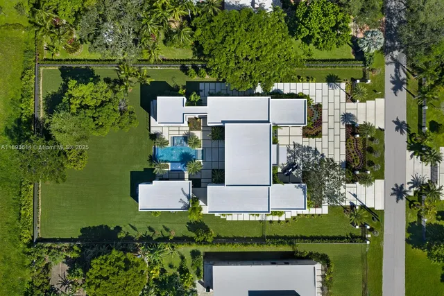 an aerial view of a house with a yard and lake view