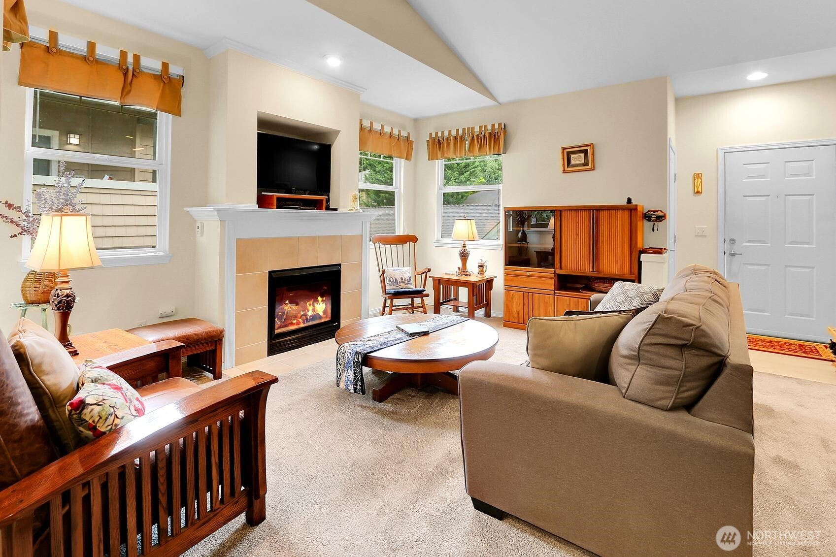 1500 South 18th Street, Unit F202 Renton, WA 98055 - Photo 5 of 20 a living room with furniture a flat screen tv and a fireplace