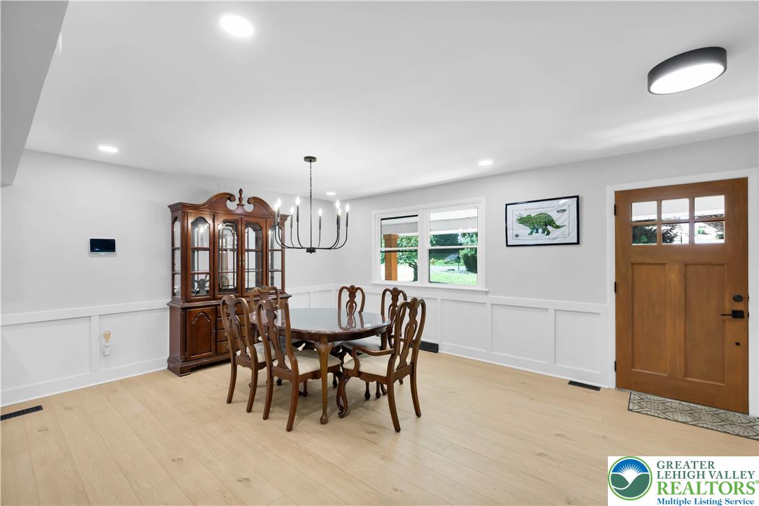 2011 Greenwood Road Allentown, PA 18103 - Photo 11 of 52 Blonde hardwood floors flow through this luminous dining area, featuring a modern chandelier and ample natural light.