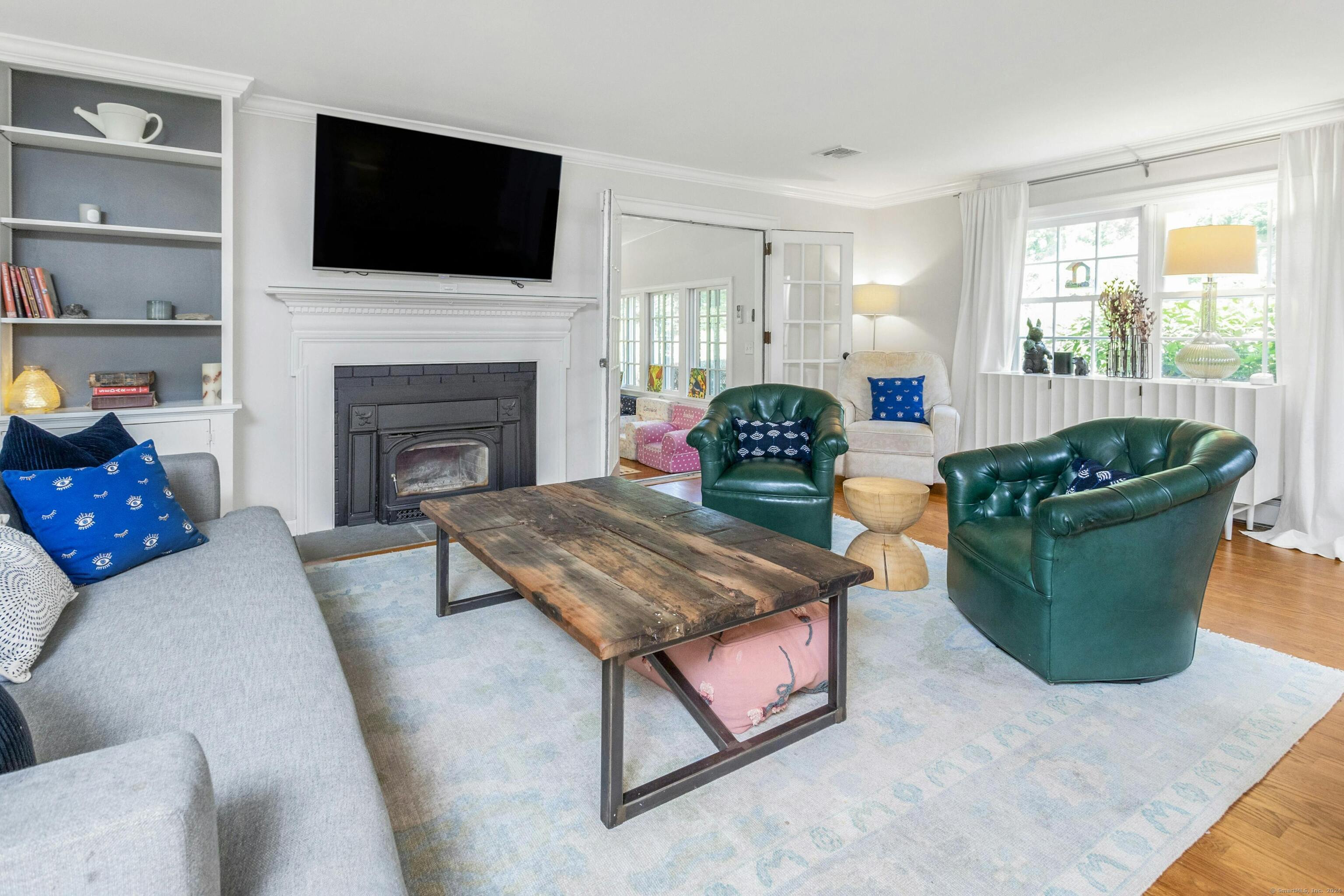 21 Roxbury Lane Wilton, CT 06897 - Photo 6 of 37 There is a fireplace and an entry to the all season sun room.