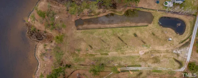 a view of a swimming pool with an outdoor seating and a lake view