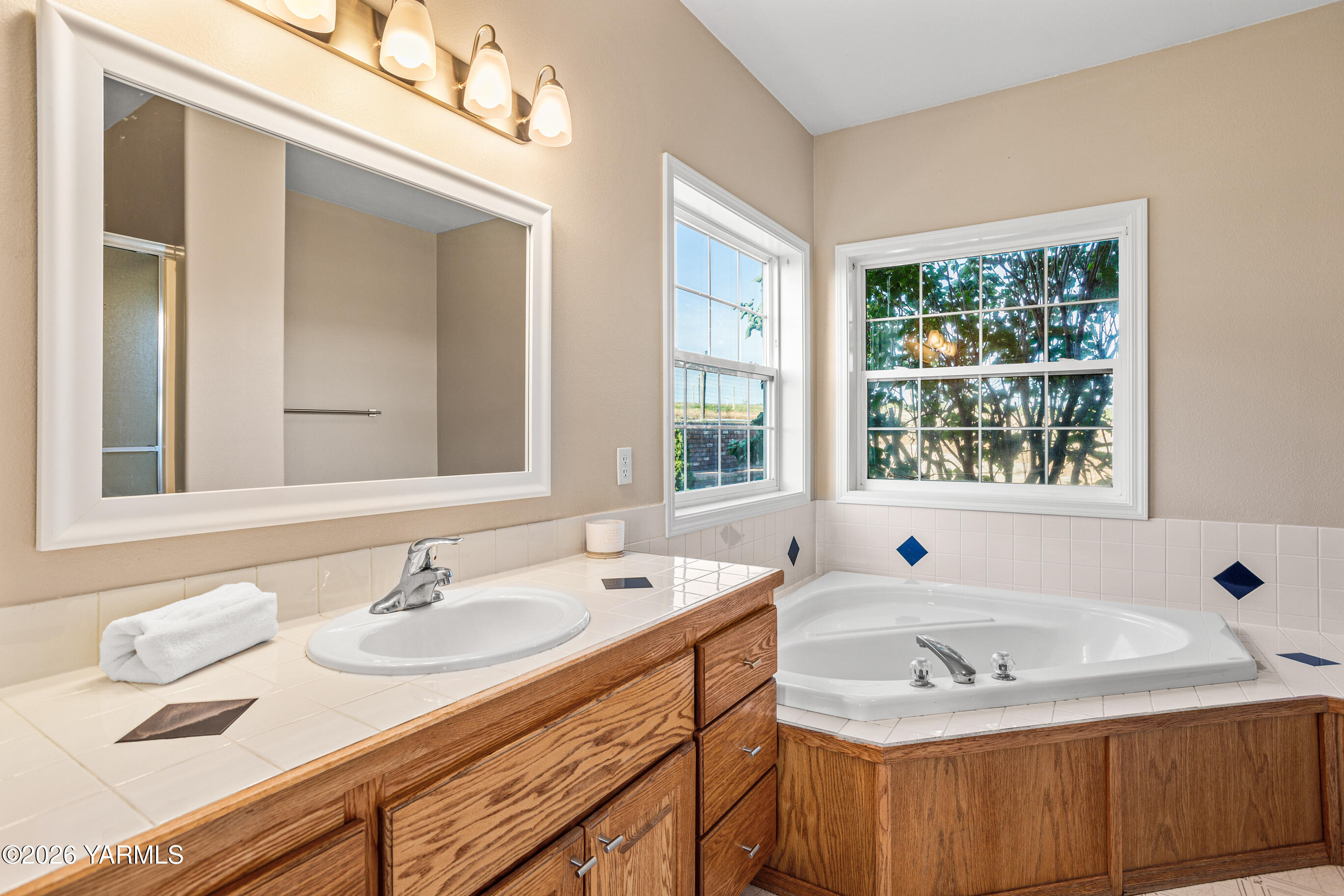 5060 Lombard Loop Road Zillah, WA 98953 - Photo 34 of 65 a bathroom with a granite countertop sink and a window