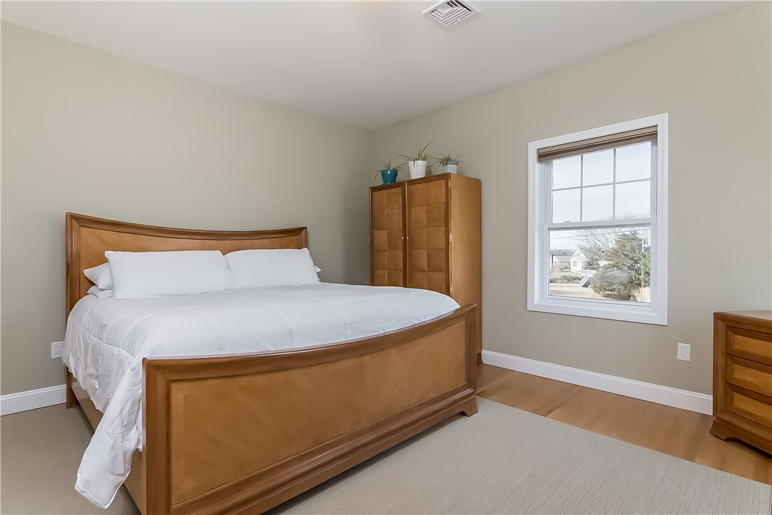 13 Nautilus Road Narragansett, RI 02882 - Photo 21 of 40 A king sized master bedroom with black-out custom blinds is perfect for catching some zzz's! Offers a double closet with custom built-ins.