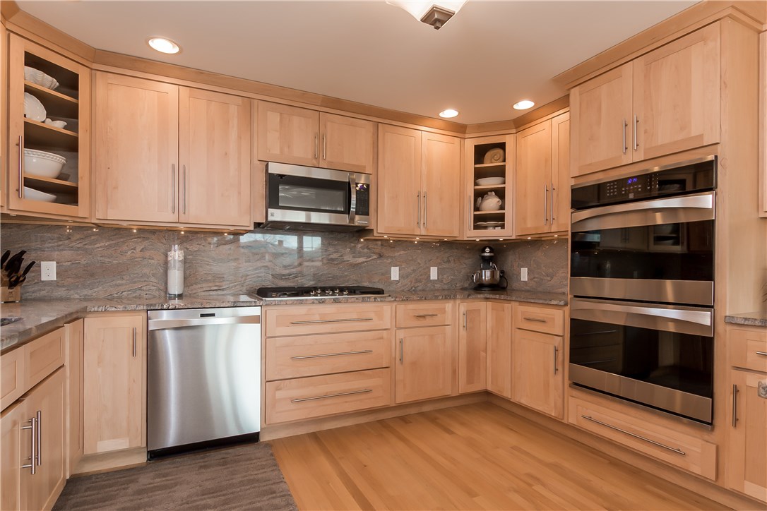 13 Nautilus Road Narragansett, RI 02882 - Photo 6 of 40 This gourmet kitchen features Maple Candlelight Cabinetry, Granite counters and backspalsh, stainless steel appliances including double ovens and a gas cook top!