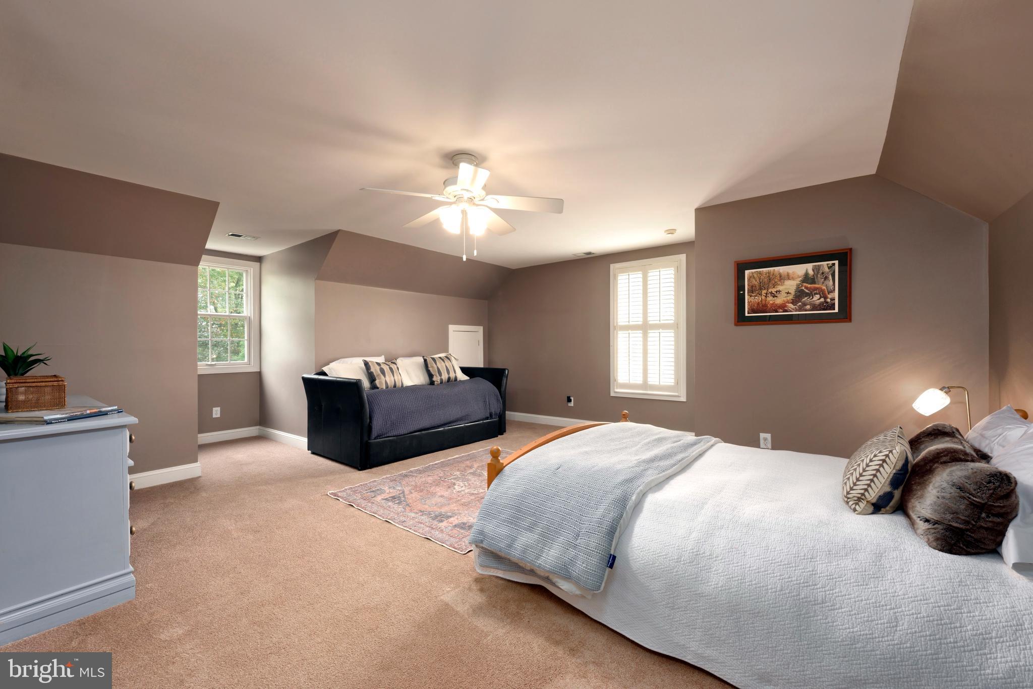 36775 Leith Lane Middleburg, VA 20117 - Photo 27 of 70 a spacious bedroom with a bed and a chandelier