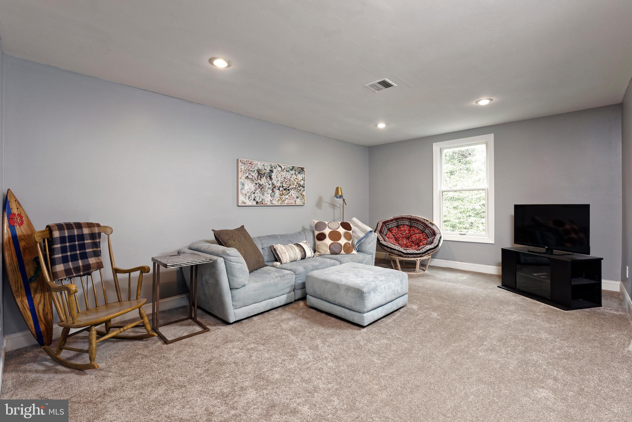36775 Leith Lane Middleburg, VA 20117 - Photo 29 of 70 a living room with furniture a flat screen tv and gym equipment
