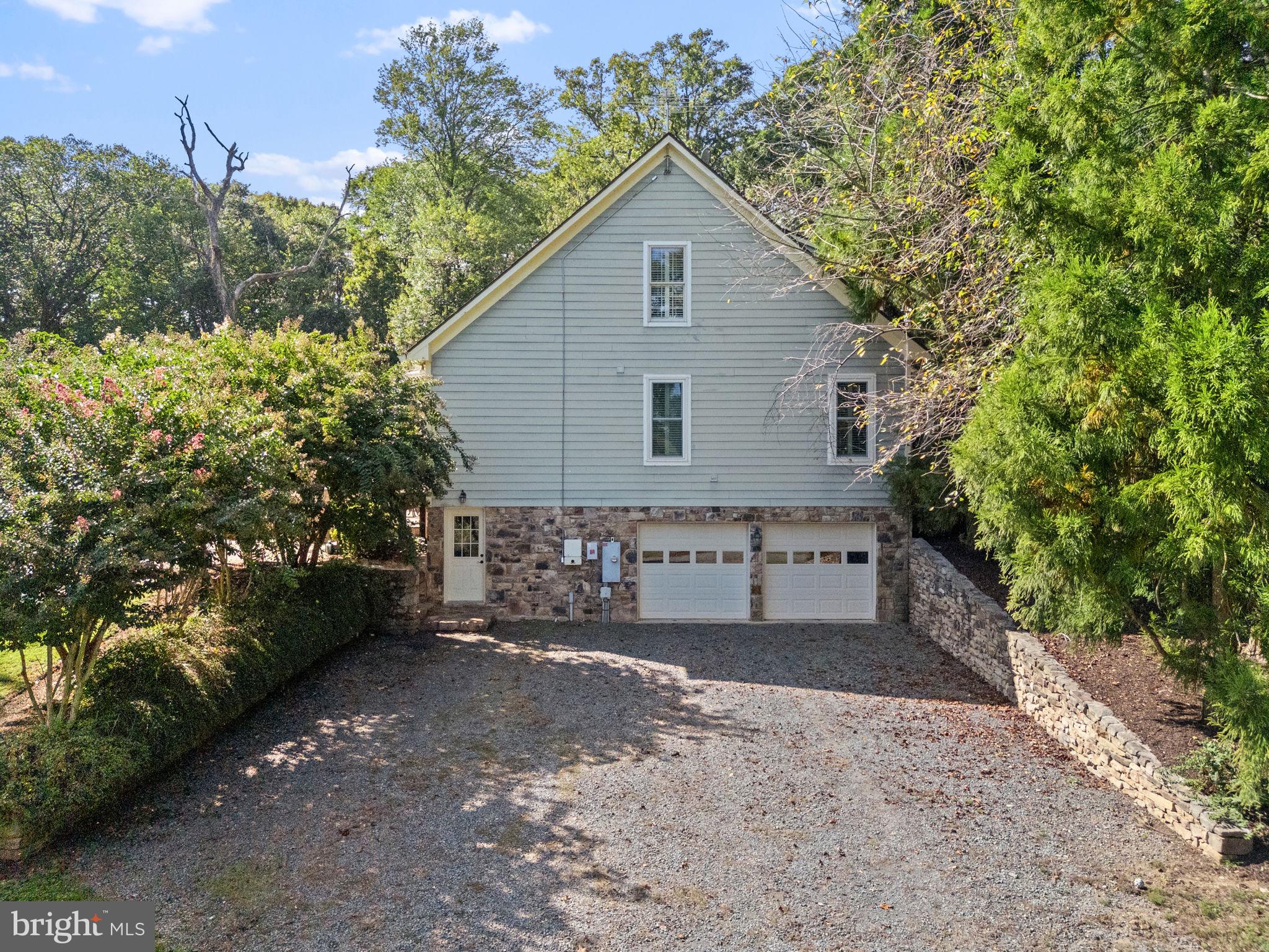 36775 Leith Lane Middleburg, VA 20117 - Photo 31 of 70 a front view of a house with a yard and garage