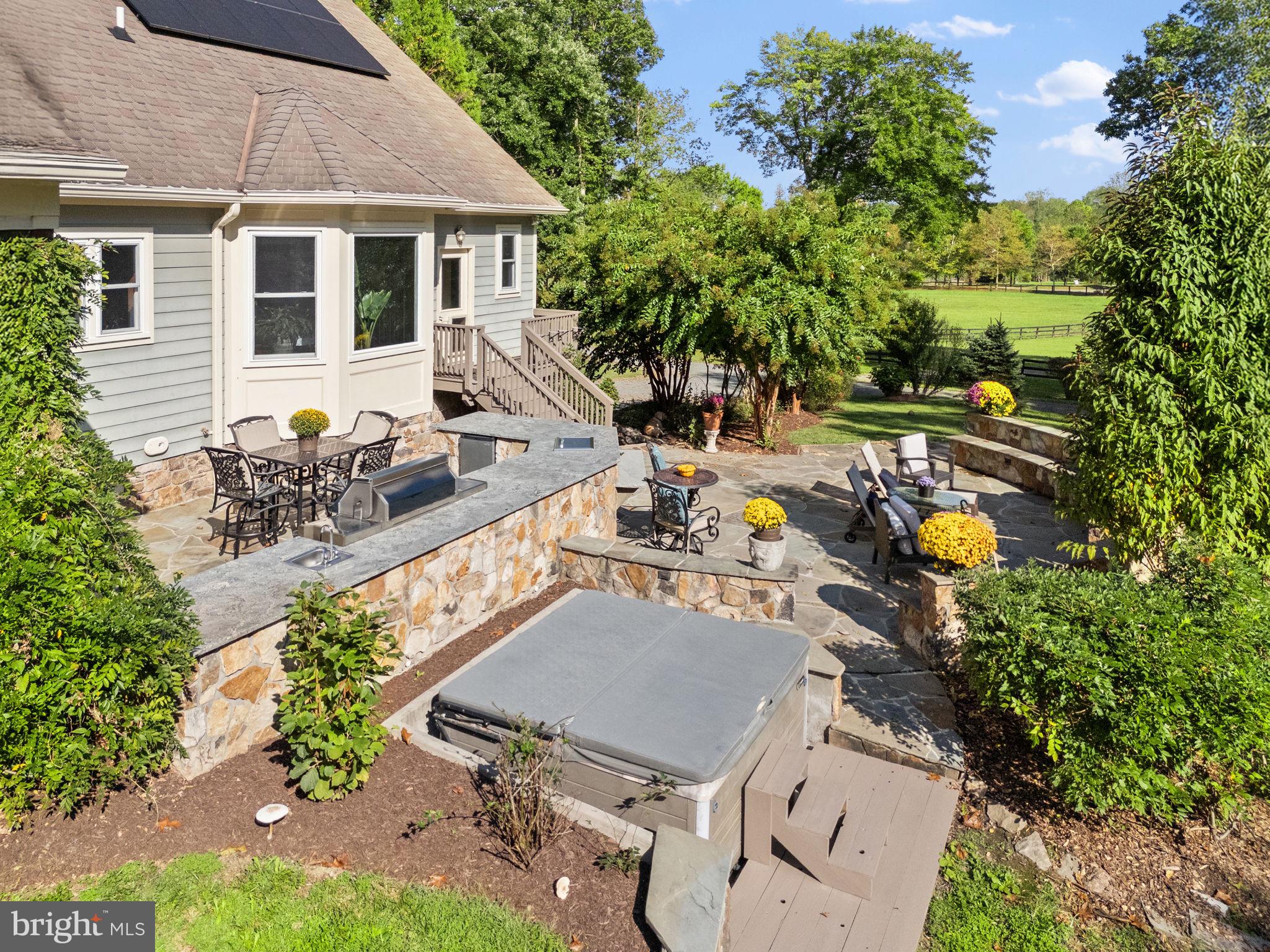 36775 Leith Lane Middleburg, VA 20117 - Photo 34 of 70 an aerial view of a house with table and chairs under an umbrella