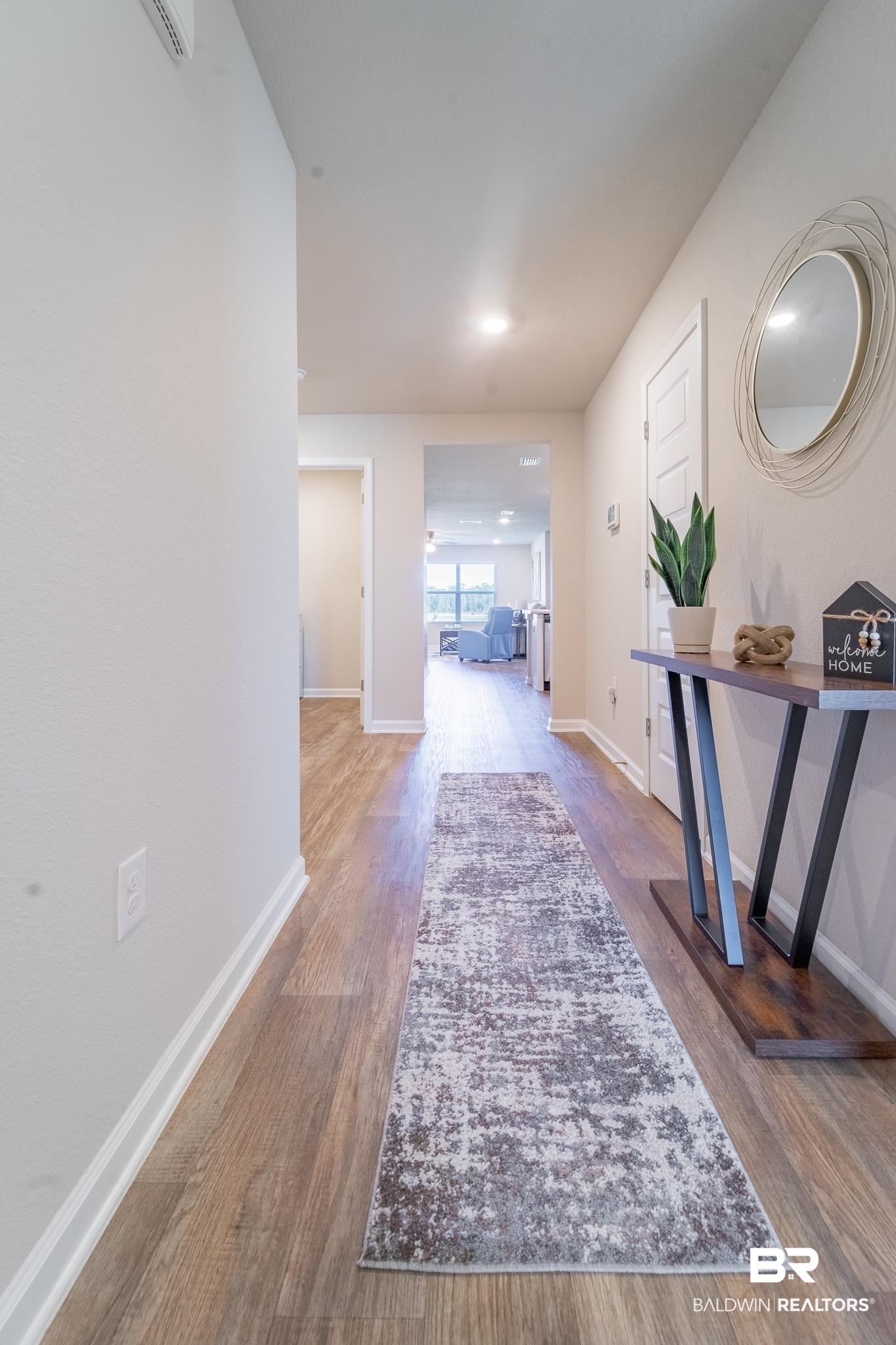Hallway with hardwood / wood-style flooring