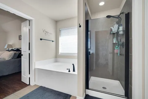 a bathroom with a shower and a sink