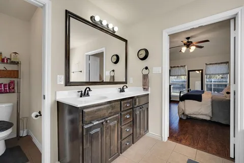 a spacious bathroom with a double vanity sink and a mirror