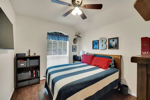 a bedroom with a bed and a chandelier