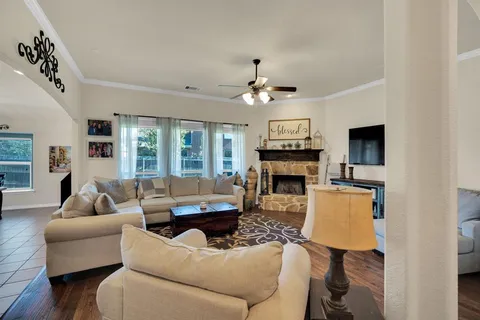 a living room with furniture a fireplace and a flat screen tv