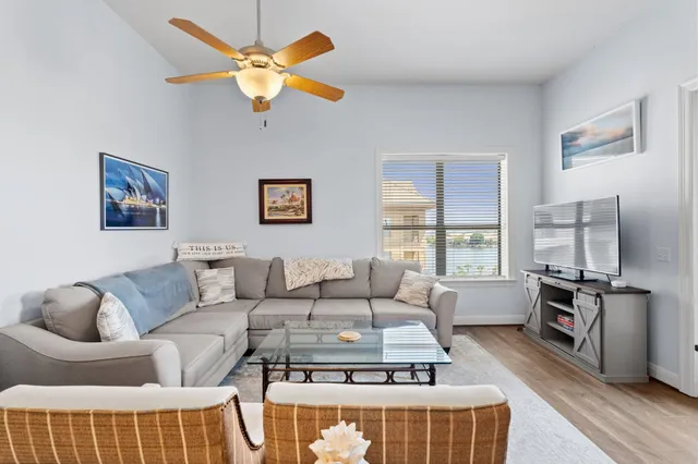 a living room with furniture a large window and a table