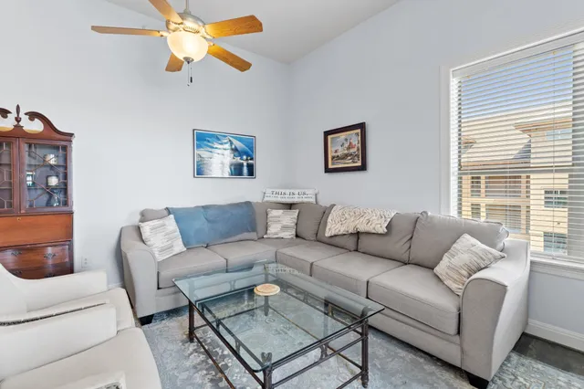 a living room with furniture a rug and a window
