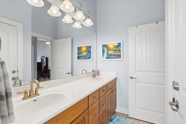a bathroom with double vanity sink and a mirror