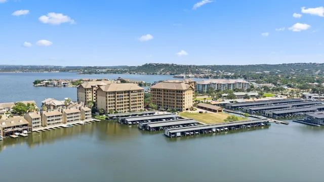 an aerial view of residential houses with outdoor space and ocean view