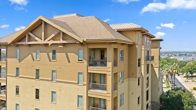 a view of a white house with large windows