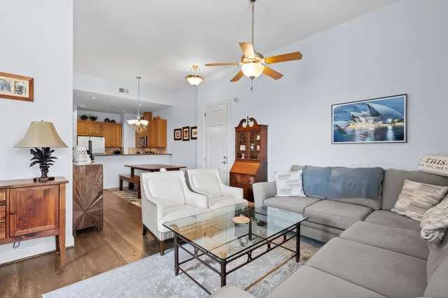 a living room with furniture a rug and a chandelier