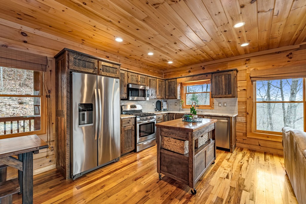 161 Cub Trail Cherry Log, GA 30522 - Photo 13 of 57 a kitchen with refrigerator a stove and cabinets