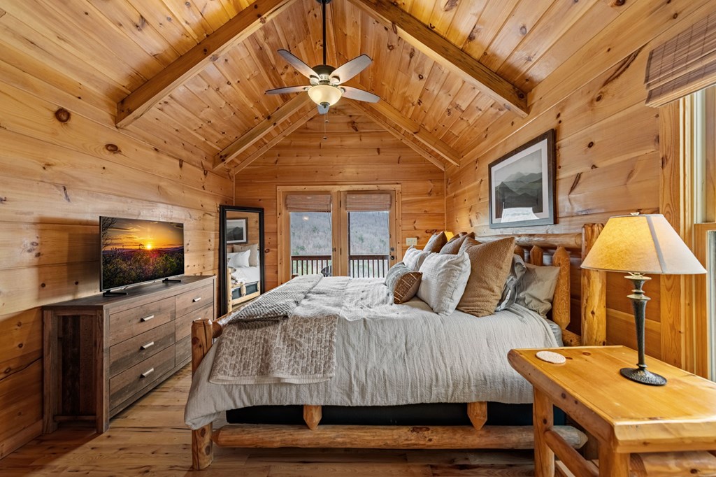 161 Cub Trail Cherry Log, GA 30522 - Photo 21 of 57 a bedroom with a bed and flat tv screen on the dresser