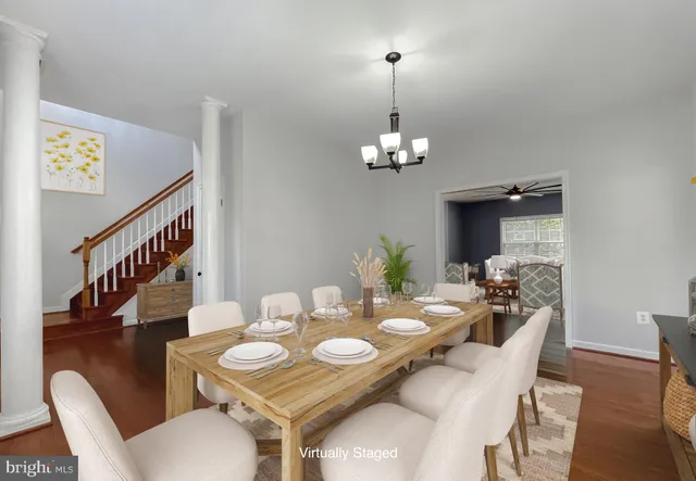 a view of a dining room with furniture wooden floor and chandelier