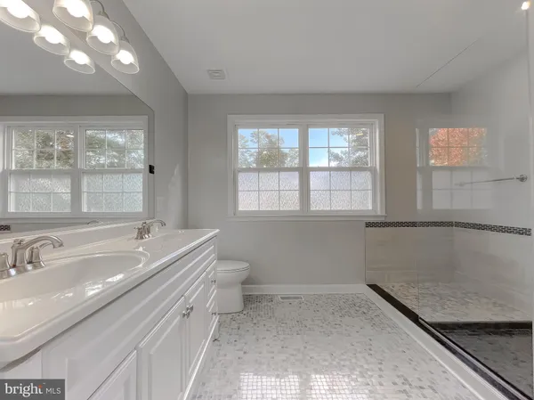 a bathroom with a granite countertop sink a toilet and bathtub
