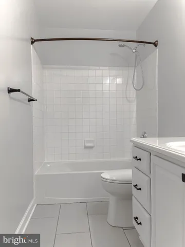 a bathroom with a shower a toilet and a sink
