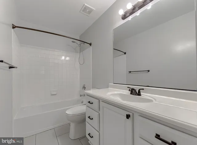 a bathroom with a sink toilet tub and shower