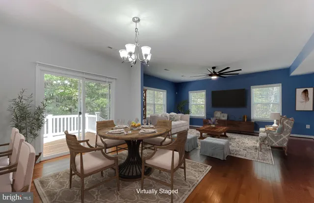 a view of a dining room with furniture wooden floor and chandelier