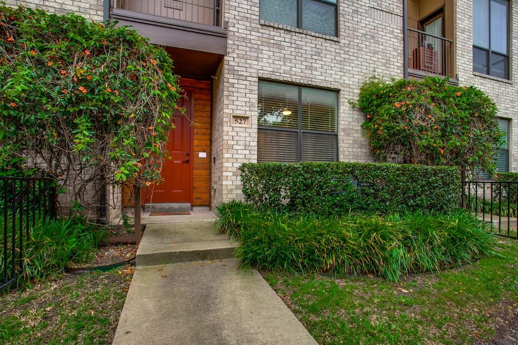 4211 Rawlins Street, Unit 527 Dallas, TX 75219 - Photo 1 of 1 a front view of a house with a yard and trees