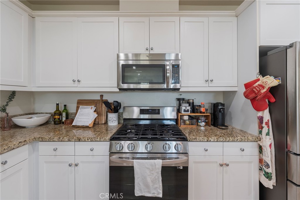 409 Mallorca Lane Brea, CA 92823 - Photo 11 of 40 a kitchen with granite countertop cabinets and stainless steel appliances