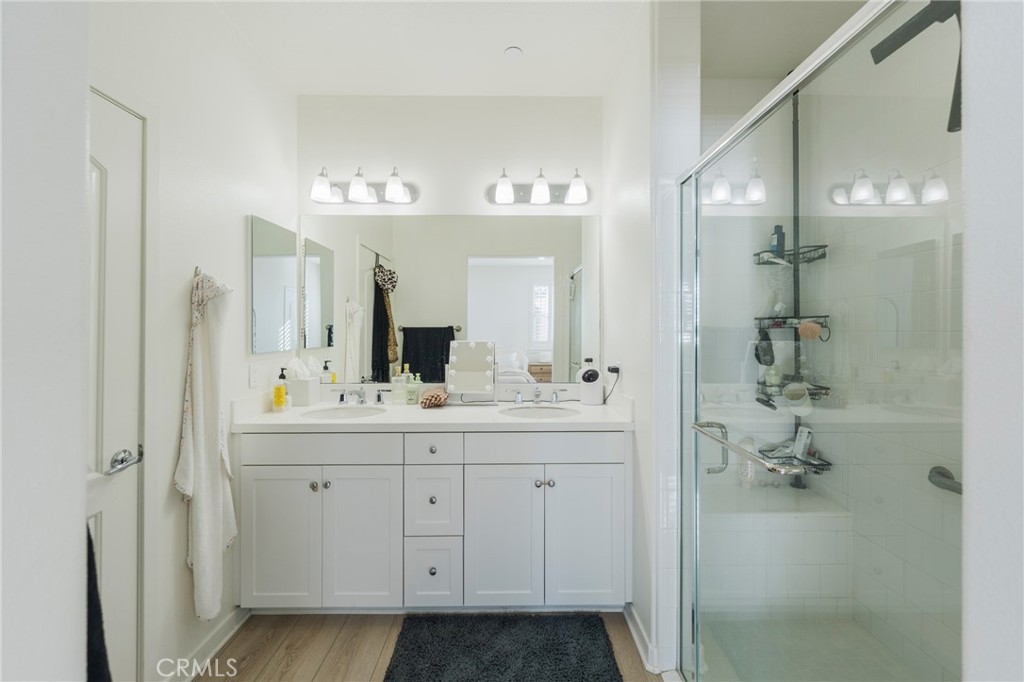 409 Mallorca Lane Brea, CA 92823 - Photo 16 of 40 a bathroom with a double vanity sink a mirror and a shower