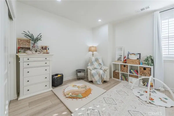 a living room with furniture and baby crib