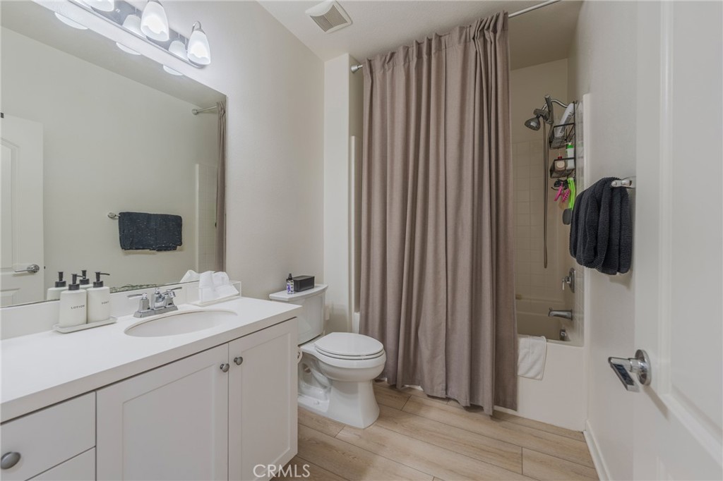 409 Mallorca Lane Brea, CA 92823 - Photo 20 of 40 a bathroom with a sink a toilet and shower curtain