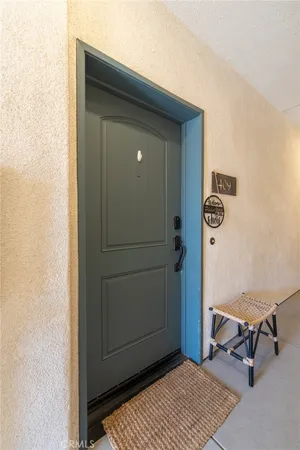 a view of a livingroom with wooden floor and a hallway
