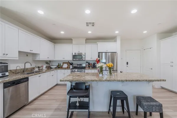 a kitchen with refrigerator and cabinets