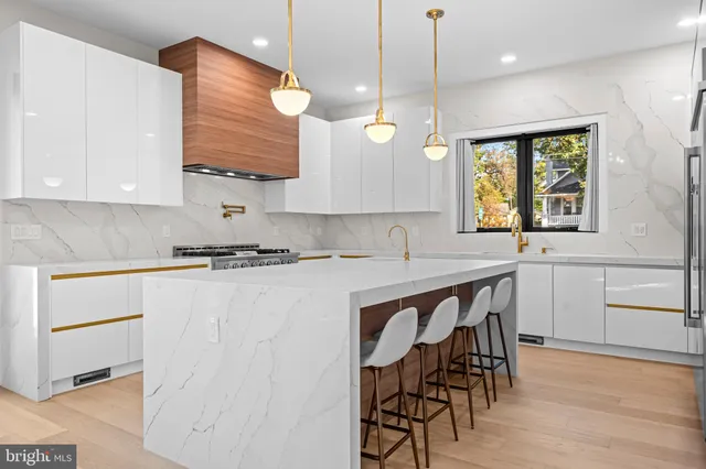 a dining room with a table chairs and kitchen view