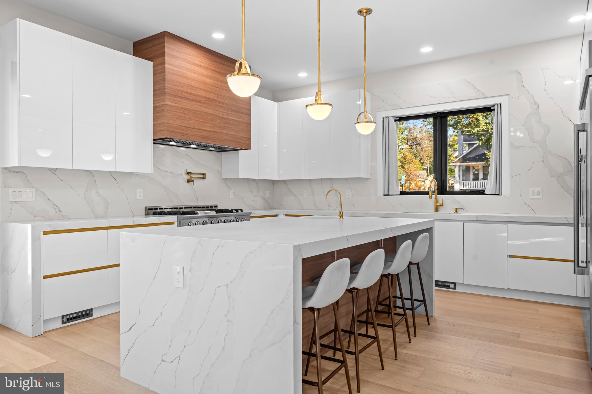4246 15th Street North Arlington, VA 22207 - Photo 12 of 72 a kitchen with a table chairs a sink dishwasher window and cabinets