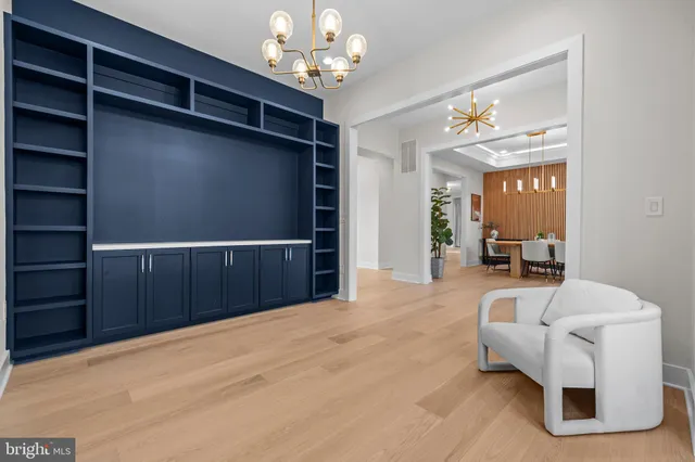 a view of an empty room with window and fireplace