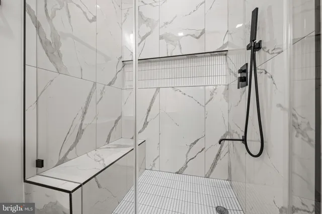 a white toilet sitting next to a bathroom shower