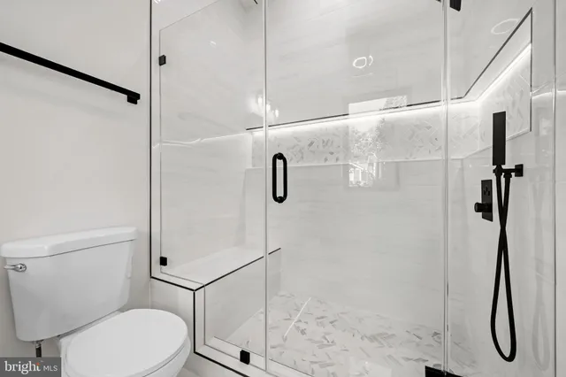 a bedroom with a bed and a wooden floor