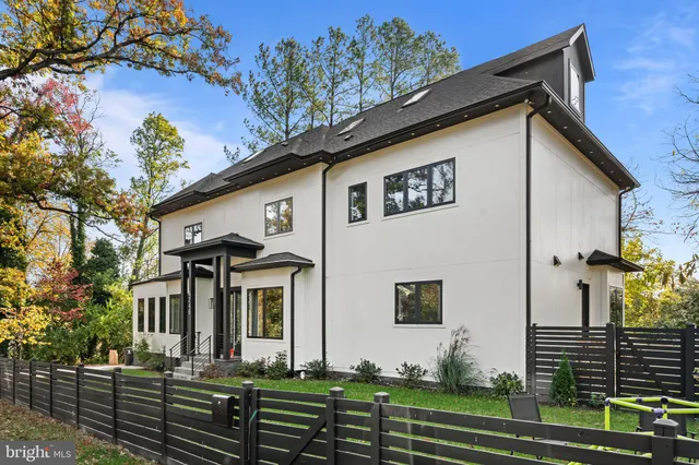 a large kitchen with stainless steel appliances granite countertop a sink a stove and a refrigerator