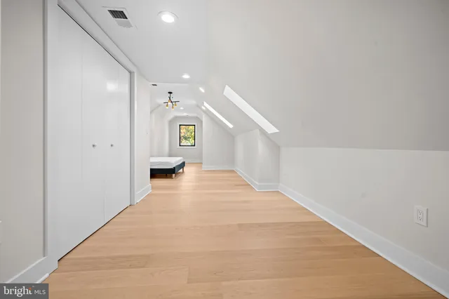 a view of a house with a small yard and wooden fence