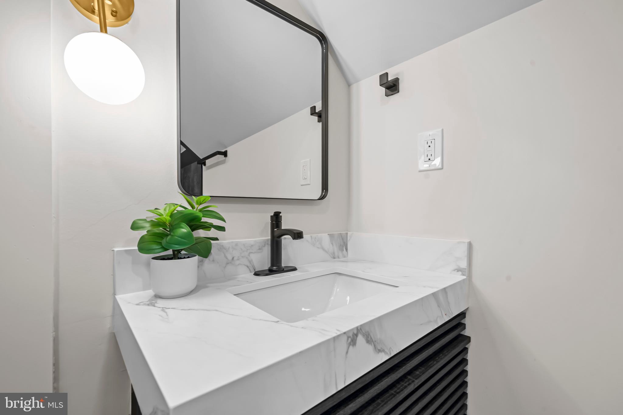 4246 15th Street North Arlington, VA 22207 - Photo 49 of 72 a bathroom with a sink and a mirror