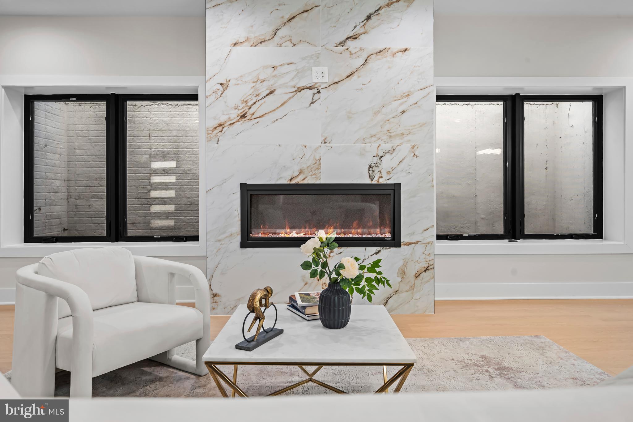 4246 15th Street North Arlington, VA 22207 - Photo 56 of 72 a living room with furniture a flat screen tv and a fireplace